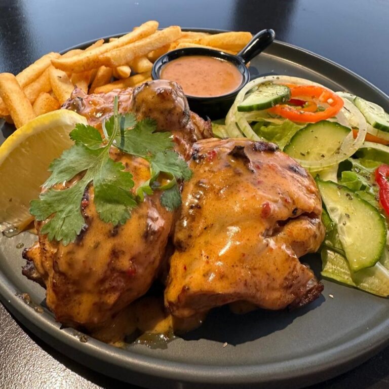 Roasted chicken with sauce, chips and salad at Match Café Muizenberg