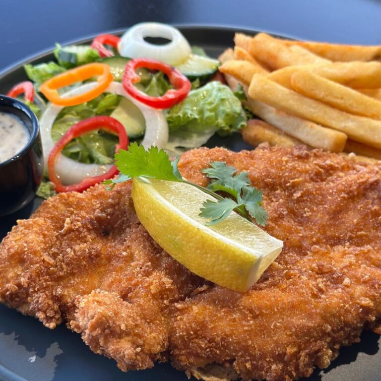 Crumbed schnitzel served with chips and salad at Match Café Muizenberg